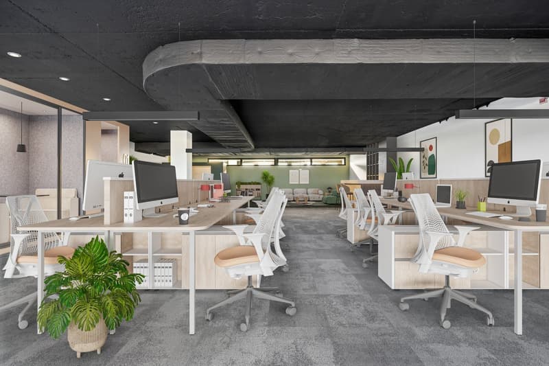 Modern open-plan office space with white desks, chairs, and computer equipment. The ceiling has a curved, textured design. There are potted plants and artwork on the walls, creating a stylish and functional work environment.
