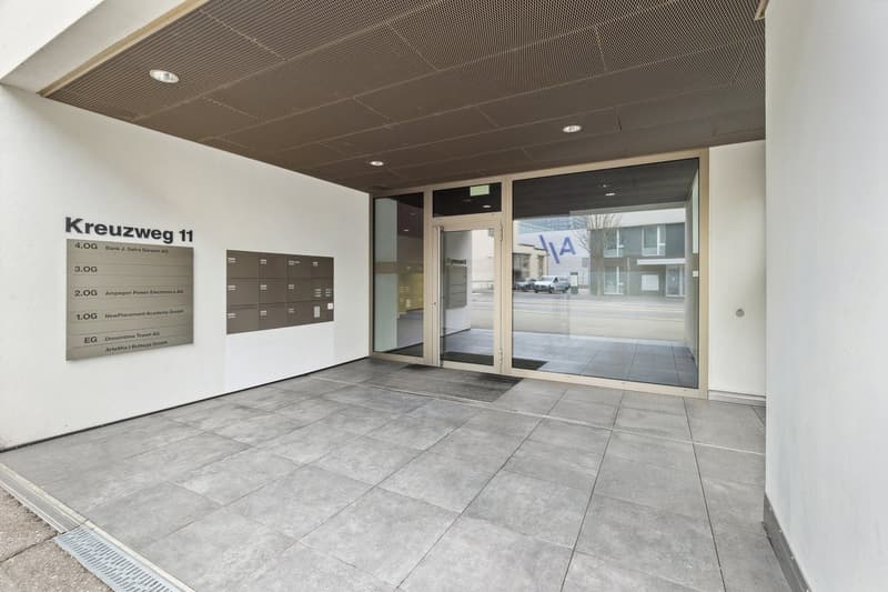 tiled floor, entrance with glass doors, security panel, tiled wall, mailboxes
