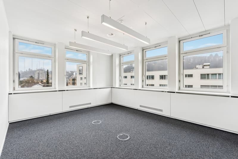 empty room, large windows, white walls, grey floor, pendant lighting