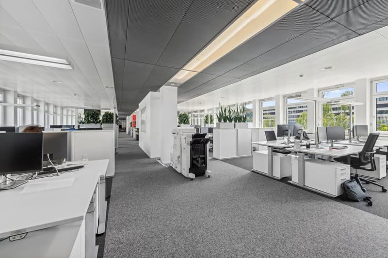 Open office space with desk, computer, and office equipment.