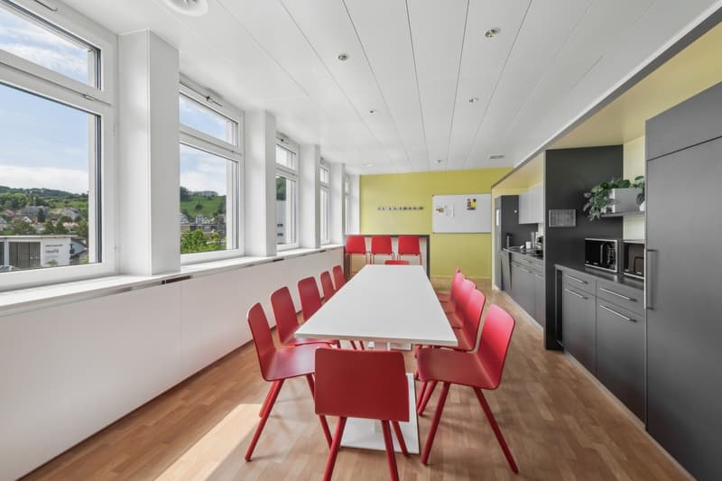 large windows, hardwood floor, modern kitchen, microwave, dining table, red chairs