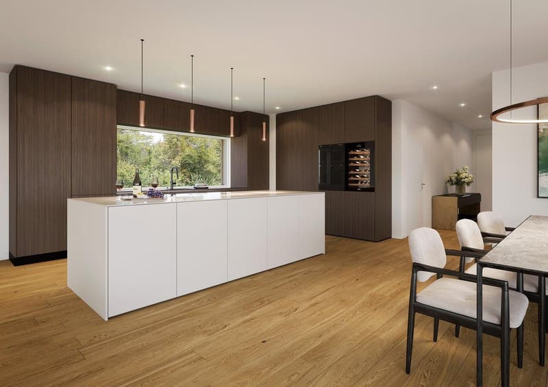 Spacious open-concept kitchen with dark wood cabinetry, white island countertop, hardwood flooring, and pendant lighting. The kitchen features a wine refrigerator and a dishwasher. The kitchen opens up to a dining area with a table and chairs.