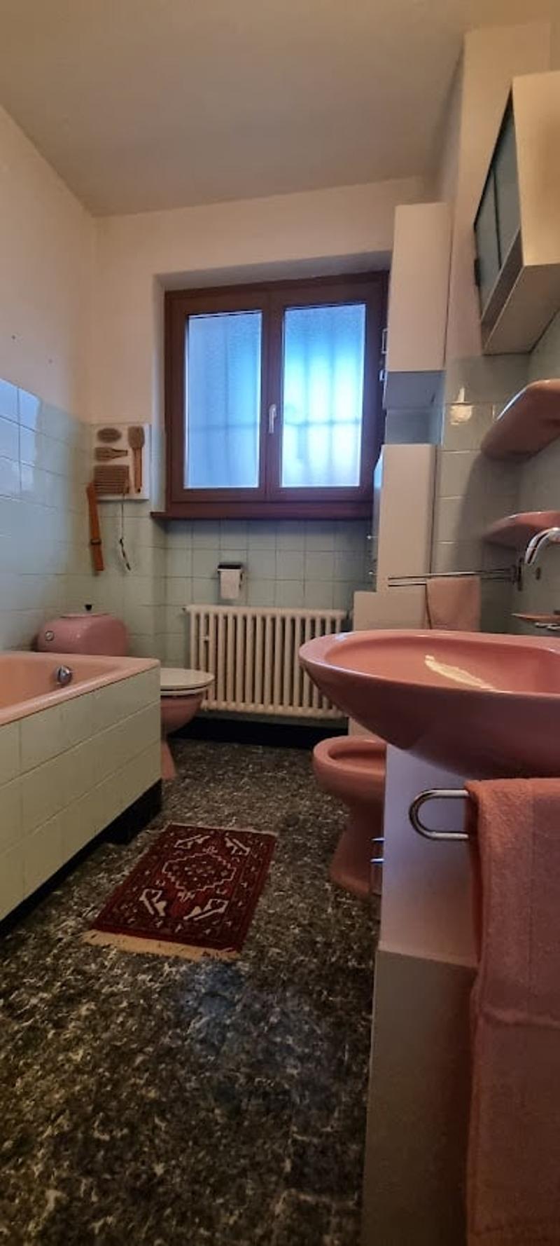 Bathroom: bathtub, sink, toilet, radiator, window