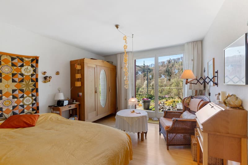 large bed, wooden wardrobe, desk, table, chair, lamp, mirror, balcony, view
