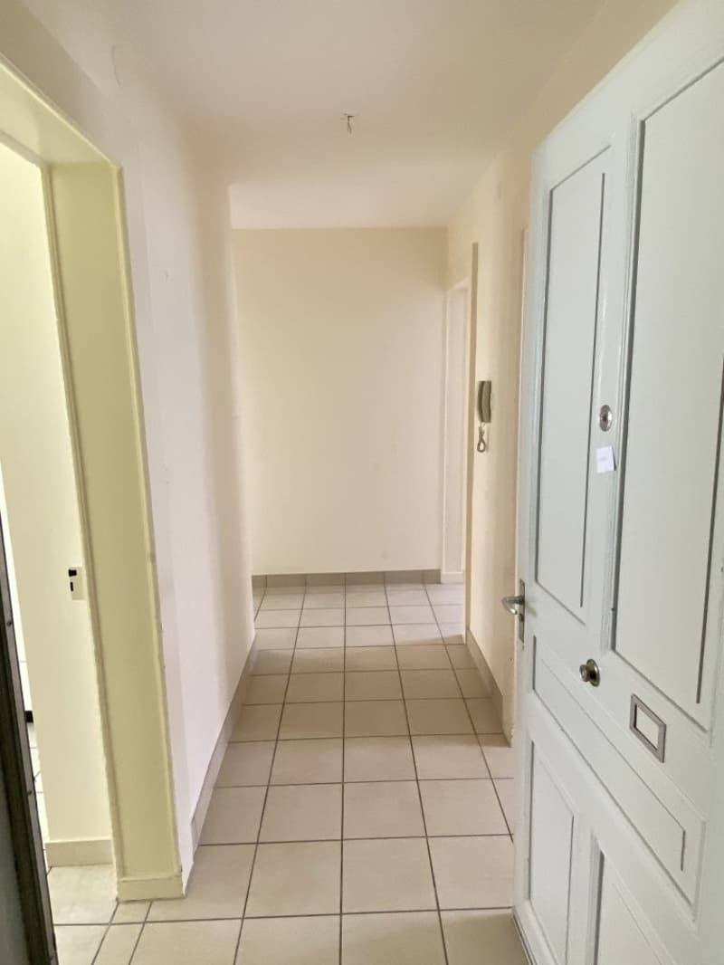 tiled floor, white walls, empty hallway