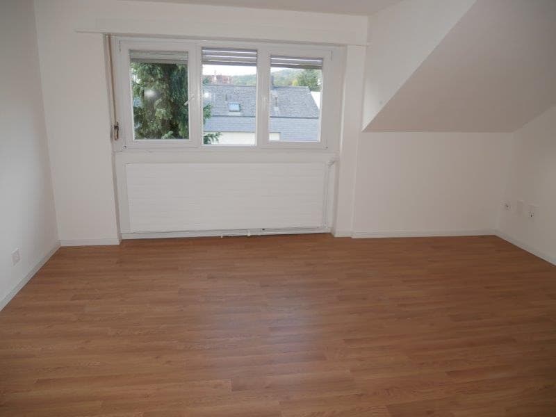 empty room, wooden floor, white walls, large window, white radiator