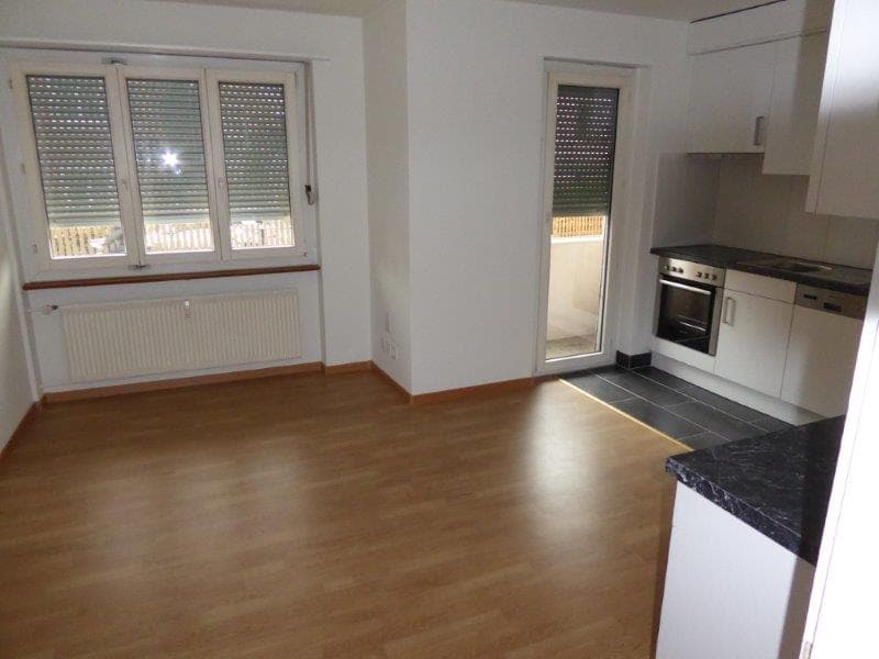 Wooden floors, open kitchen, sliding glass door, white radiator, large windows, glass windows
