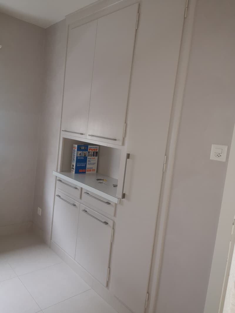 modern white built-in cabinets, white floor, power outlet on the wall