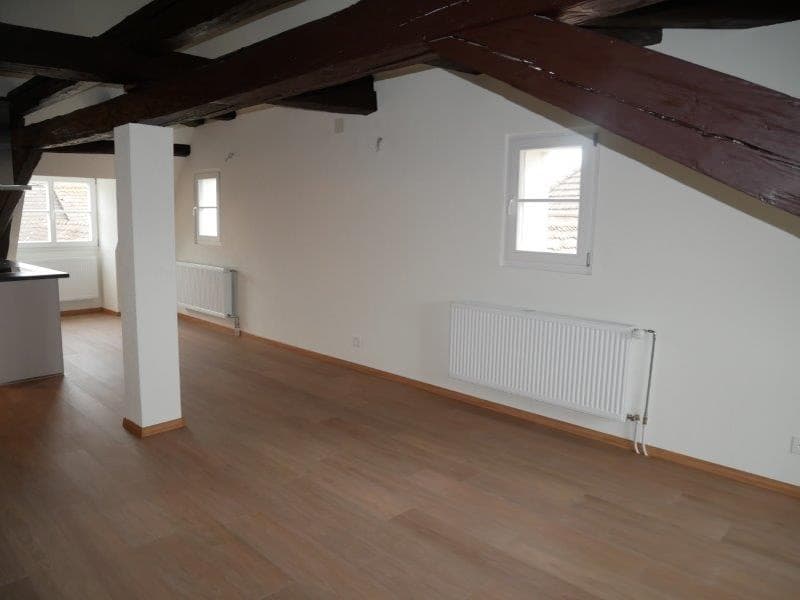empty room, wooden floors, white walls, wooden beams, two windows, two radiators