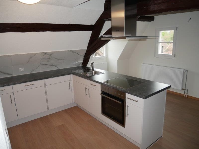 a modern kitchen with wooden floor, white cabinets, granite countertops, electric stove, oven, kitchen island, sink, faucet, wooden beams, glass window