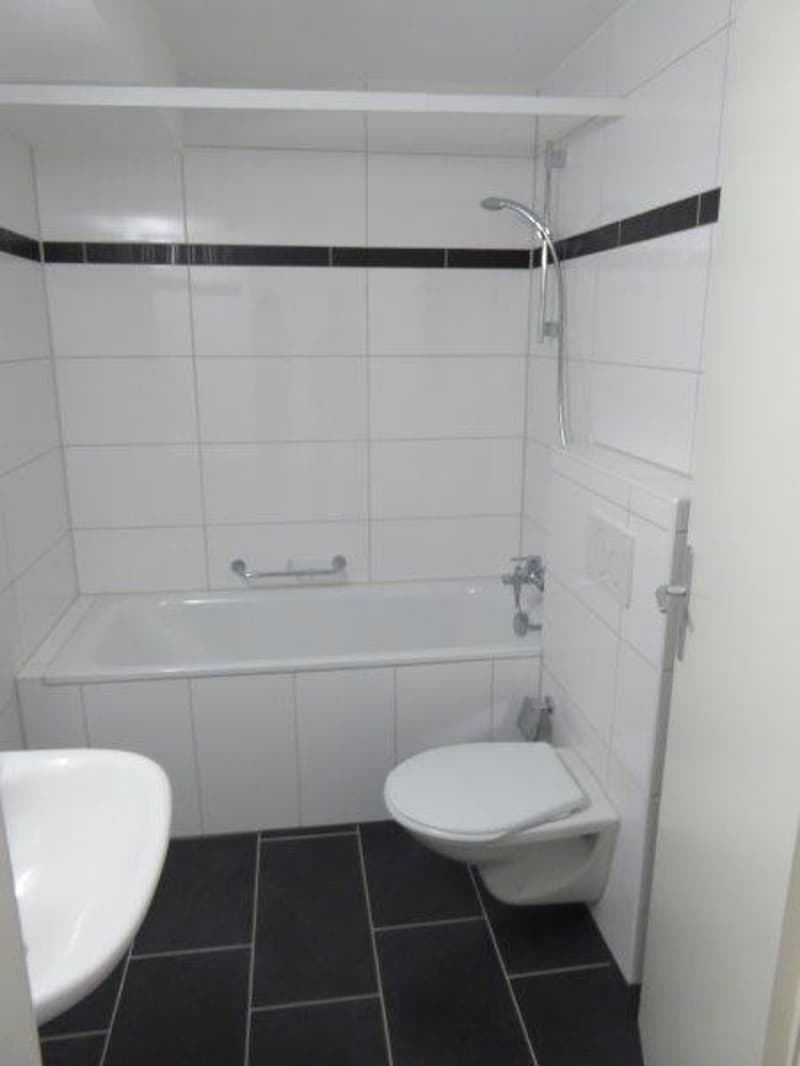 Bathroom: tile flooring, bathtub, shower, toilet, sink