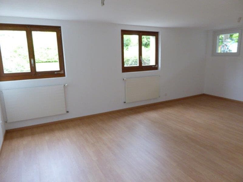 Empty room, wooden floors, white walls, windows, radiators