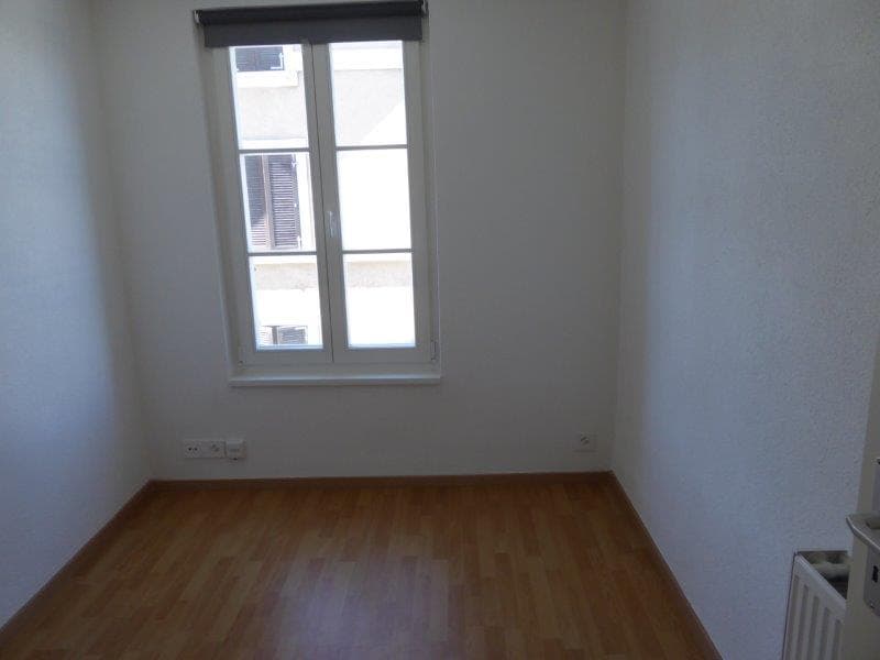 empty room, white walls, wooden floor, window, power outlets, small heater