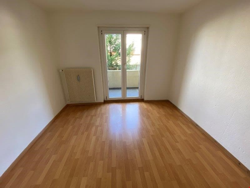 empty room, wooden floors, glass door, radiator