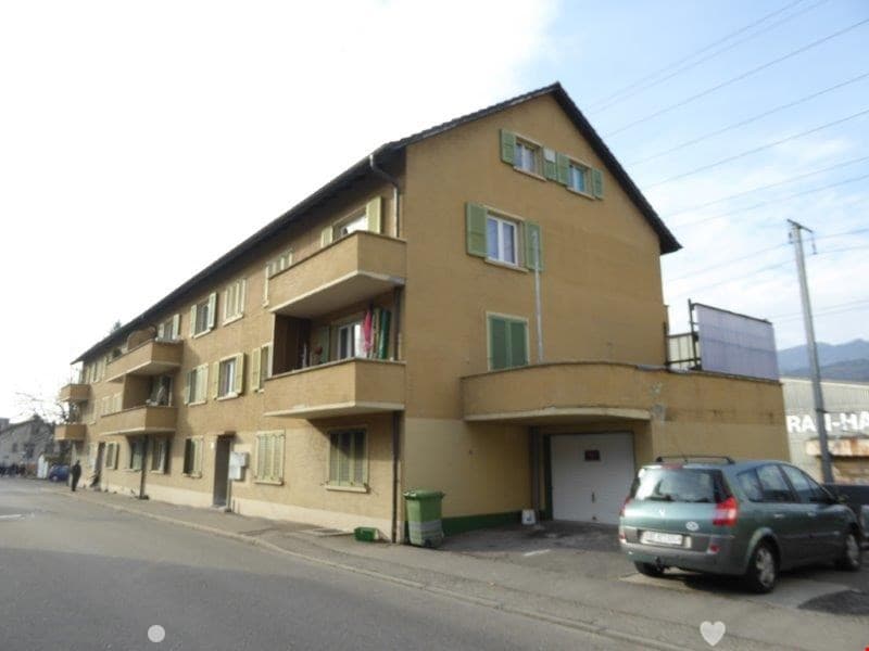 3 story house, beige paint, balconies, garage