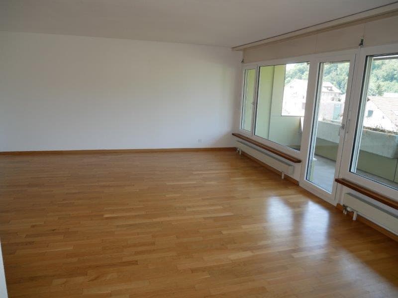 empty room, wooden floor, white walls, large windows, balcony