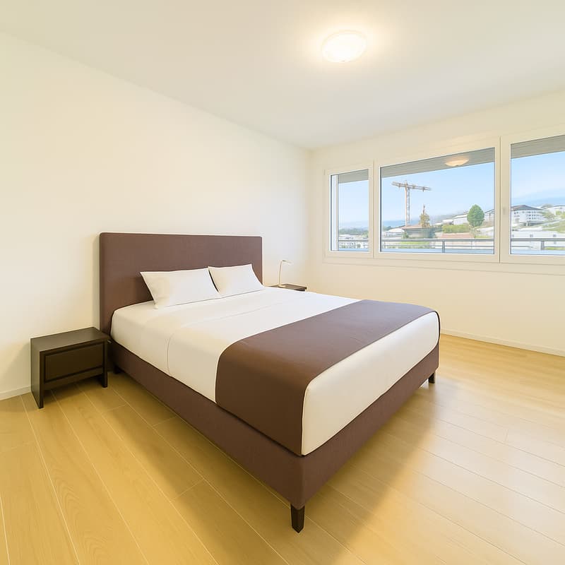 bedroom with wooden floor, bed, nightstands, windows, lamp, pillows