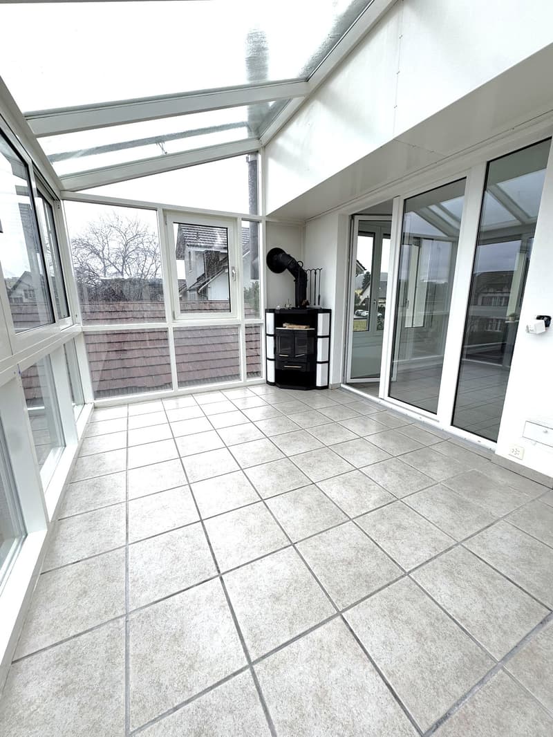 large open terrace, glass walls, square tiles, wood stove, heating unit