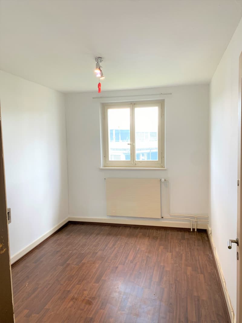 empty room, white walls, wooden floor, window, radiator