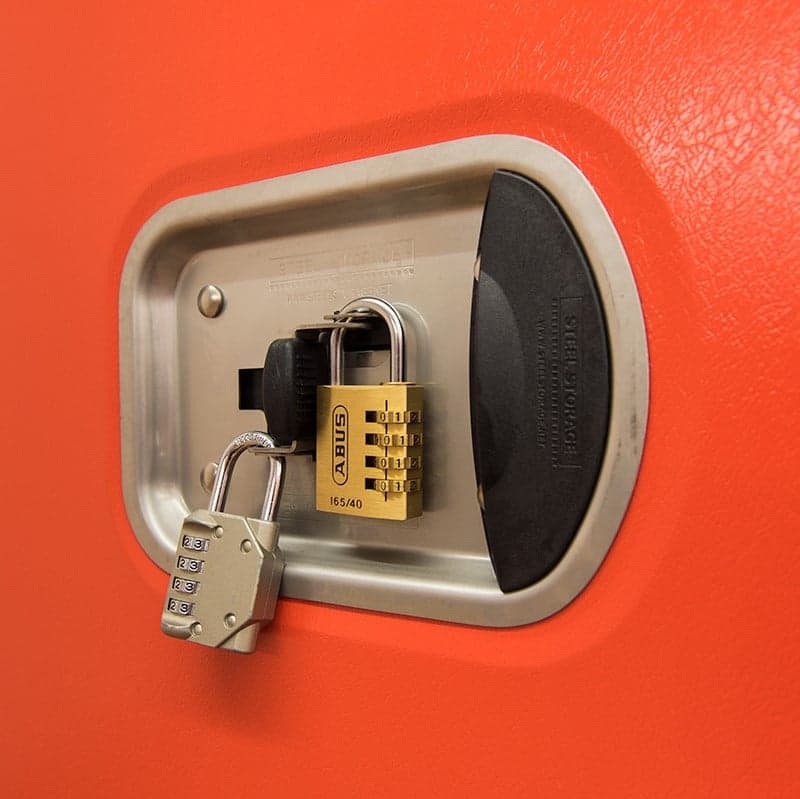 Wall-mounted storage unit with a combination lock and a padlock attached to it.