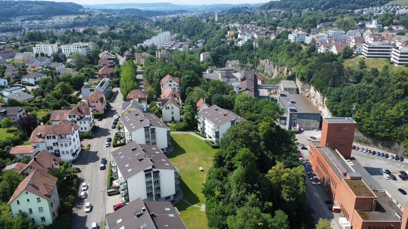 urban residential area with multiple buildings and parking areas