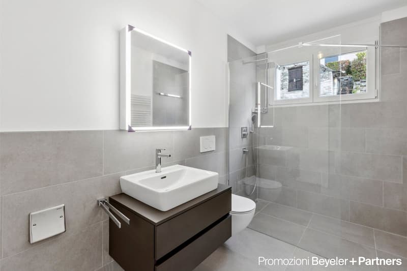 modern bathroom, grey tiles, white sink, mirror, shower, toilet, large windows