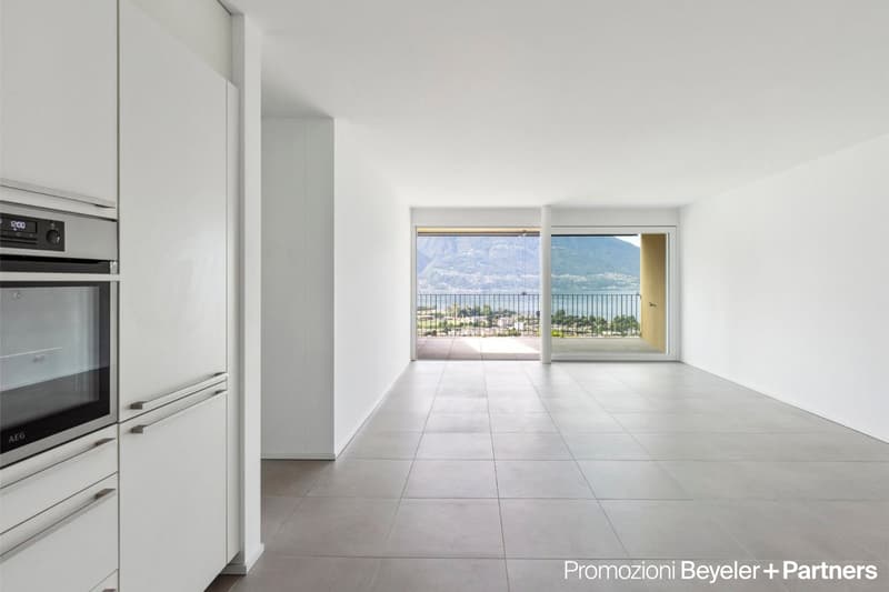 tiled floor, white cabinets, kitchen appliances, balcony with railings, glass door, view of the lake and mountains