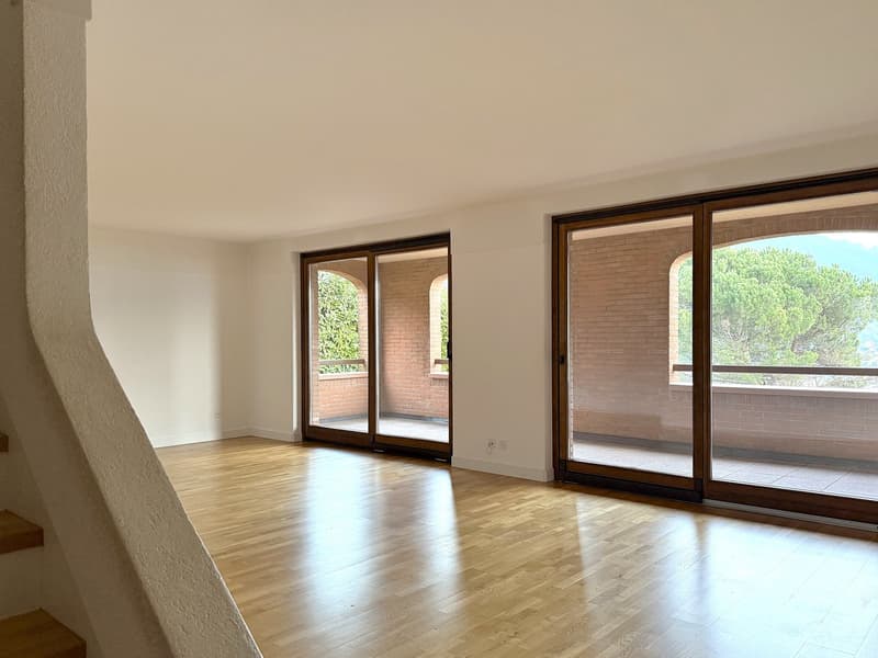 empty room, wooden floors, white walls, sliding doors, balcony with brick wall