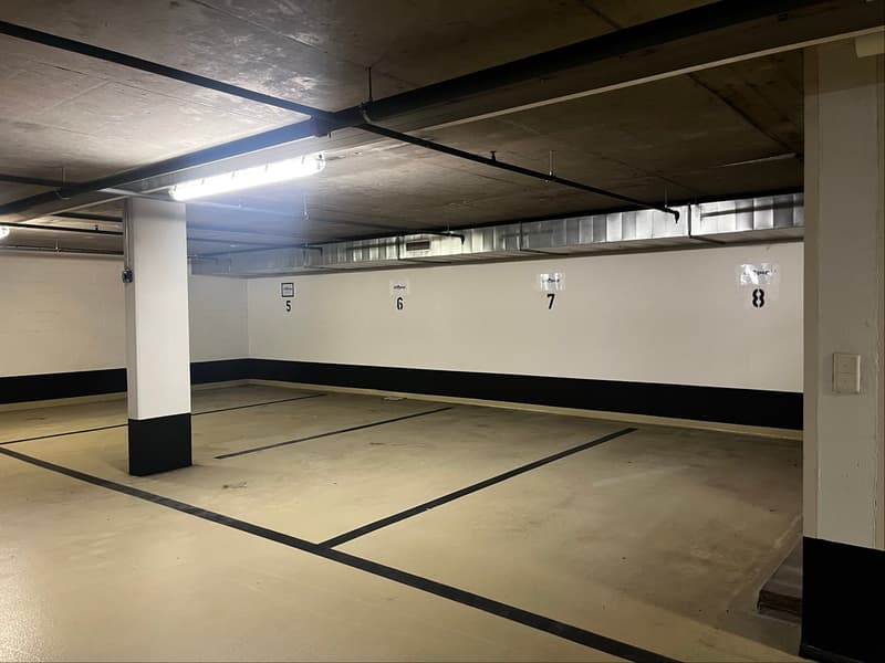 empty parking area, lights, number markings on the wall