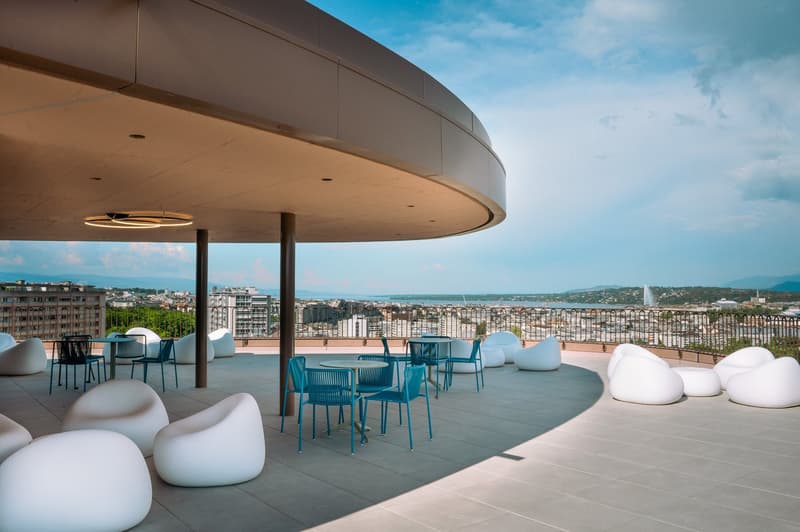 Rooftop terrace, modern seating, round table, city view, blue furniture