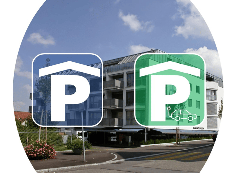 Signs for parking spots in front of a residential building with electric vehicle charging symbol