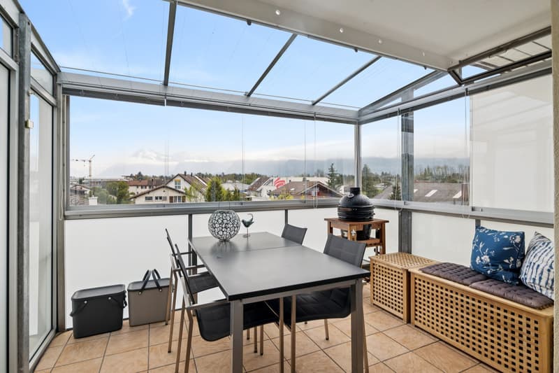 Ein lichtdurchfluteter, vollständig verglaster Balkon eröffnet einen freien Blick auf die eindrucksvolle Bergwelt.