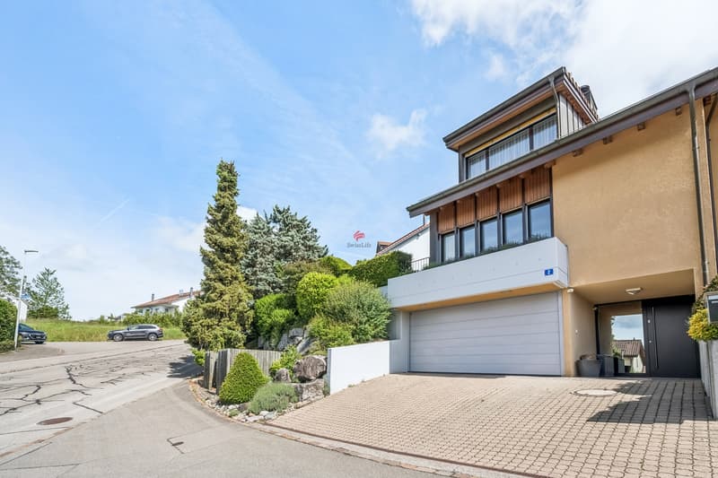 Gepflegte Doppelhaushälfte mit Auffahrt und Garage. / a modern home with a driveway and garage on a sunny day