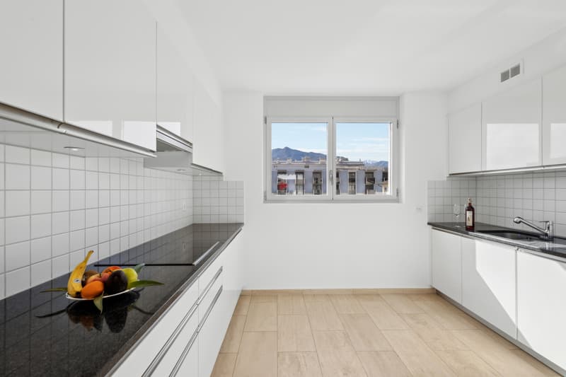 Die separate Küche ist modern gestaltet, mit viel Stauraum und trendigen Oberflächen / La cucina separata è in stile moderno, con ampi spazi di contenimento e finiture di tendenza.