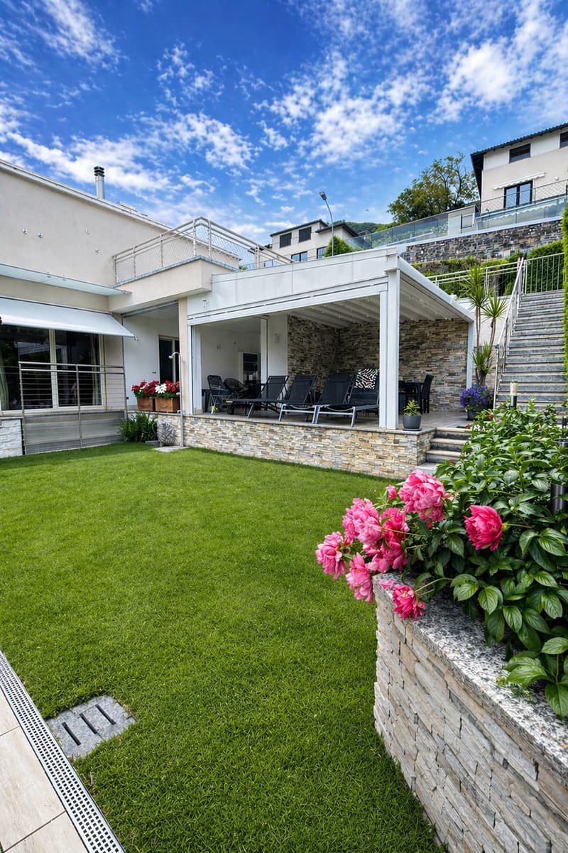 modern house, large terrace, outdoor seating, garden, brick wall, flowers