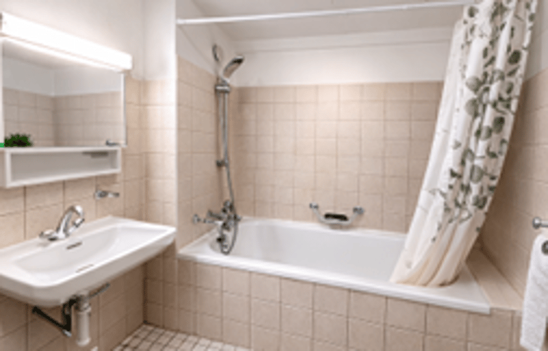 Bathroom with bathtub, sink, mirror, shower curtain, towel rack