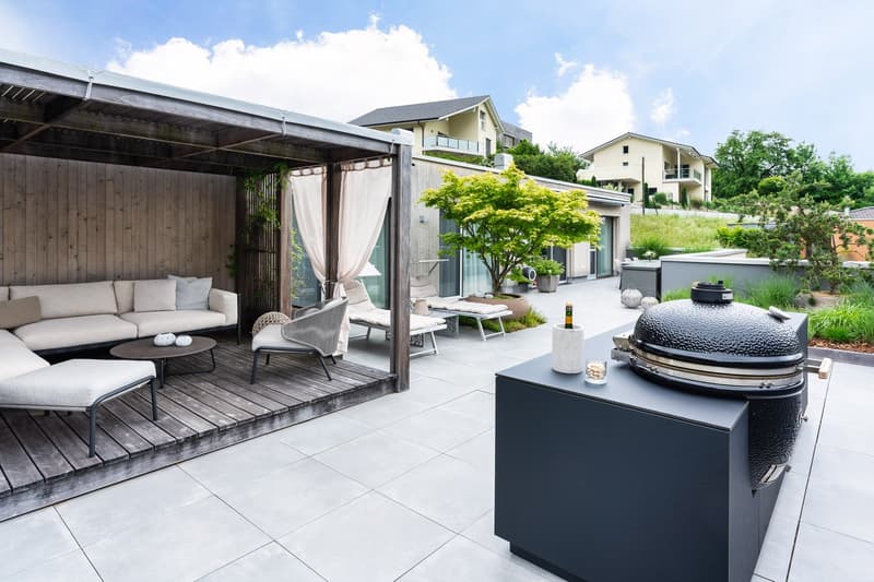 Wooden deck, outdoor sofa, wooden table, outdoor grill, plants, tiled floor, view of houses