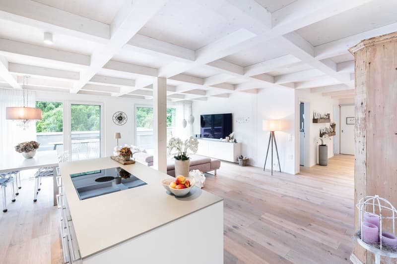 Open kitchen, dining area, living room, balcony, modern design, wooden floors, white walls, large windows, chandelier, TV, couch, flowers, lamps, cabinets, baskets, vases