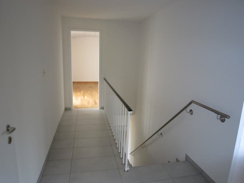 white walls, white tiles, white railings, open door