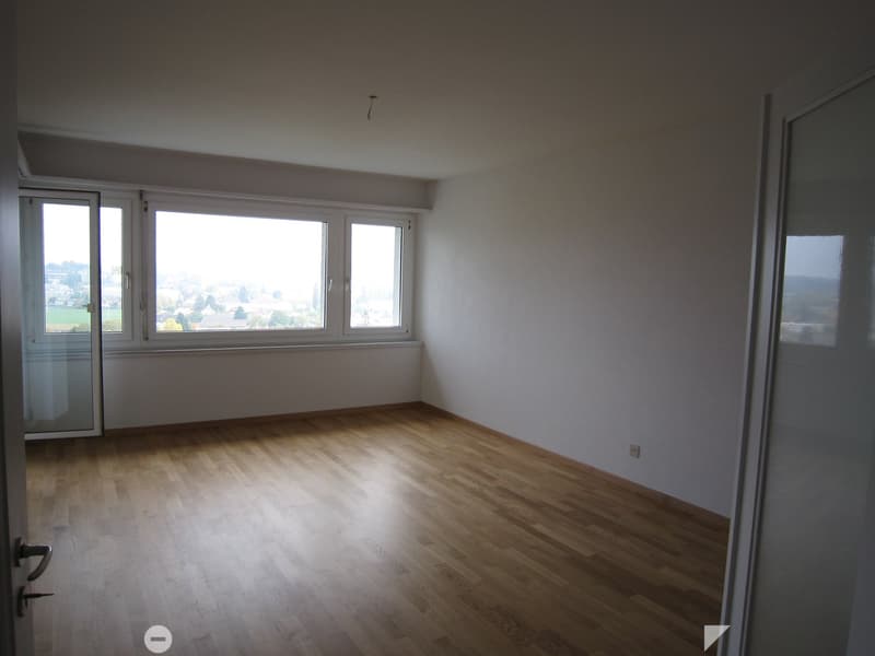 empty room, wooden floor, large windows, white walls, power outlet