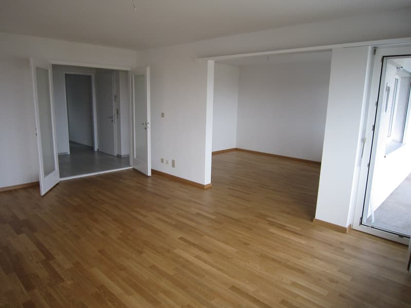 empty room, wooden floor, white walls, open doors, balcony