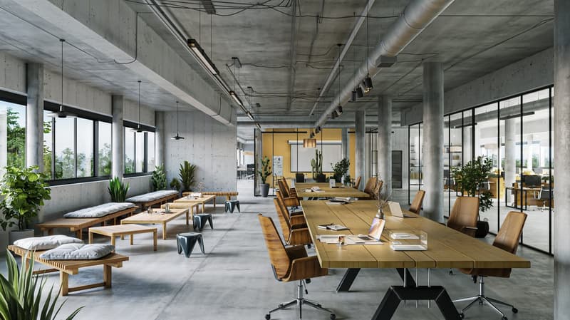 large room with desks, wooden chairs, lots of plants, benches, windows