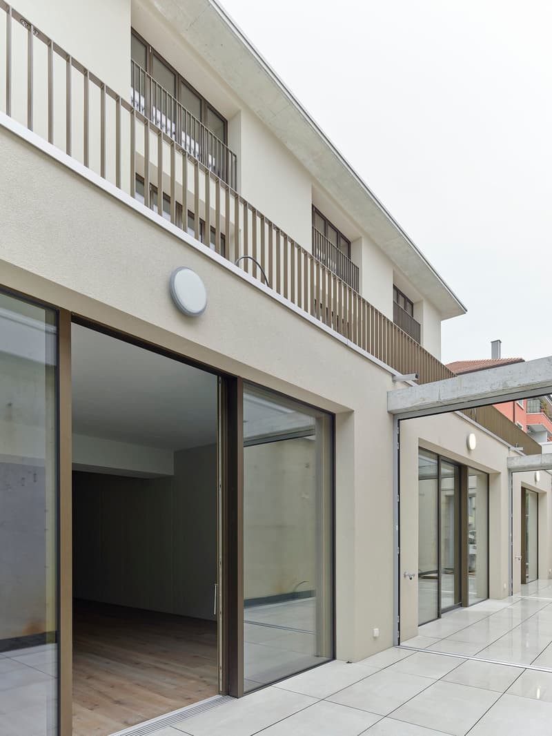 modern apartment building, balcony, large glass windows, metal railings, tiled flooring