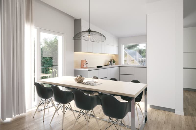 The image shows a modern, open-concept kitchen and dining area. The kitchen features white cabinets, a gray countertop, and a pendant light fixture. The dining table is made of light-colored wood and is surrounded by black chairs. Large windows provide na