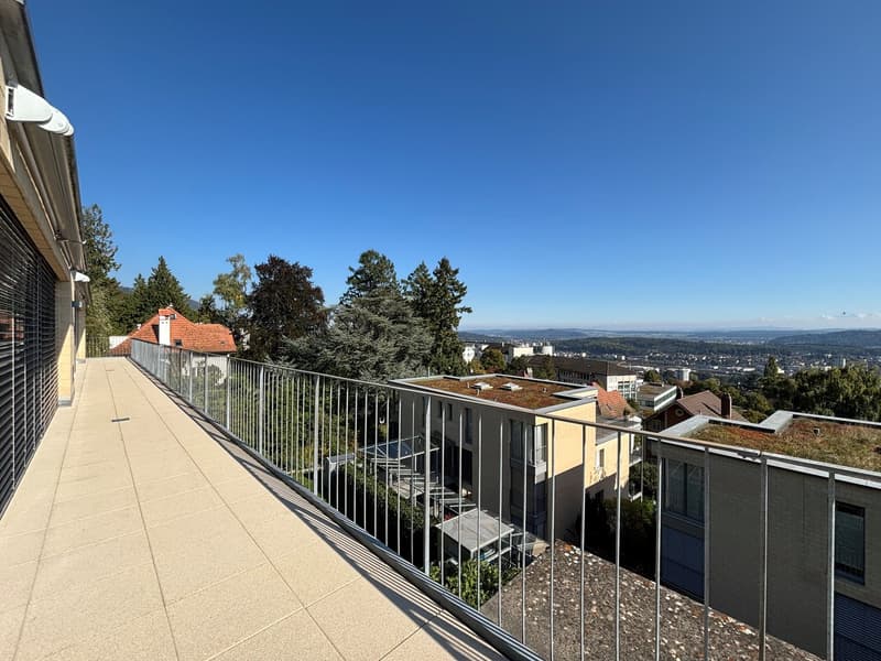 large terrace with metal railing, tiled floor, view of the city