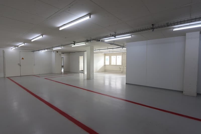 empty basement, fluorescent lighting, red lines on floor