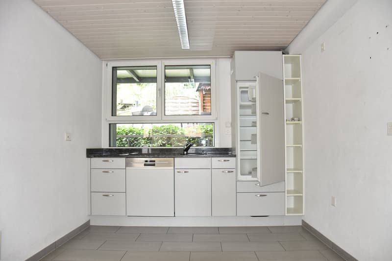modern kitchen with white cupboards, granite countertop, built-in dishwasher, washing machine, large window