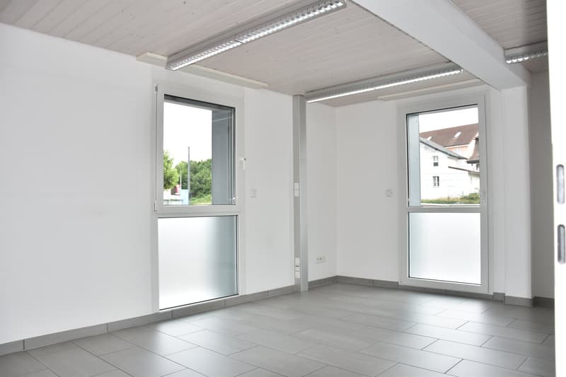 empty room, glass doors, light tiled floor, white walls, ceiling lights