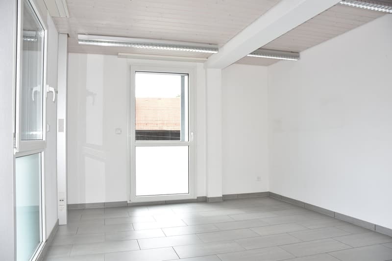 Empty room, white walls, gray tile floor, window, entrance door, power outlets, LED lights