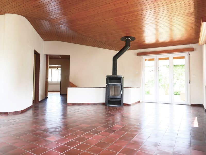 empty room, red tile floor, wooden ceiling, fireplace, sliding glass doors